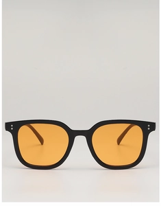 Detail of square black frame sunglasses with orange lenses and silver rivet accents