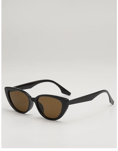 Detail view of vintage cat-eye sunglasses with black glossy frames and brown lenses