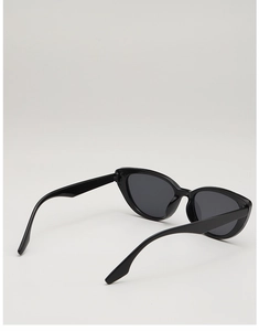 Detail view of vintage cat-eye sunglasses with glossy black frames and dark sun lenses