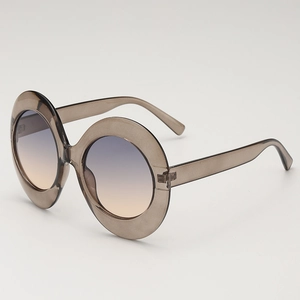 Vintage oval oversized sunglasses with translucent grey frames and gradient lenses