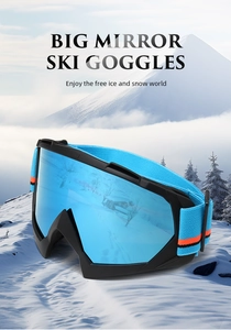 Big mirror ski goggles with blue spherical lens placed on a snowy mountain background