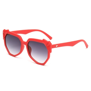 Fashionable oversized red sunglasses with geometric frames and gold wing accents