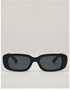 Detail view of glossy black rectangular sunglasses with dark tinted lenses and thick frames