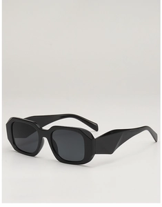 Detail view of bold geometric black sunglasses with thick acetate frames and sculptural arms