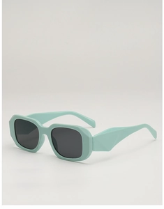 Close-up of mint green geometric thick frame sunglasses with faceted temple details