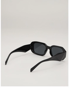 Detailed view of black wide-frame geometric sunglasses with 3D angular temple design