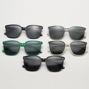 Detail of square oversized sunglasses showing various colors and metallic rivet accents