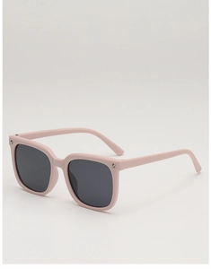 Pink oversized kids sunglasses with metal star studs and dark grey UV lenses