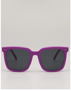 Detail view of purple kids sunglasses featuring star accents and dark resin lenses