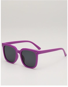 Detail of purple children sunglasses with star accents and dark lenses on white background
