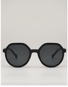 Close-up of stylish oversized black hexagonal sunglasses with dark grey polarized lenses
