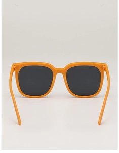 Detail view of vibrant orange oversized kids sunglasses with stylish rivet accents