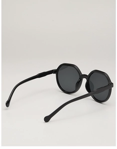 Close-up of black polygonal sunglasses with dark lenses and comfortable round temple tips
