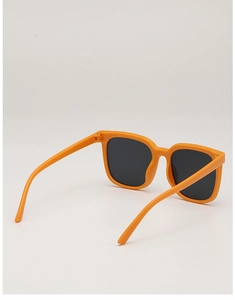 Detail view of stylish orange matte square frame sunglasses with dark polarized lenses