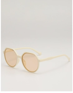 Detail view of cream white polygon frame sunglasses with orange tinted lenses