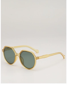 Detailed close-up of yellow translucent octagonal frames and wave-shaped sunglass temples