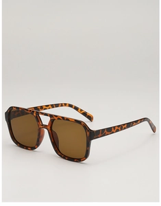 Detailed close-up of oversized square sunglasses featuring leopard print frames and double bridge