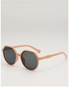 Detail view of stylish matte beige octagonal round sunglasses with grey lenses