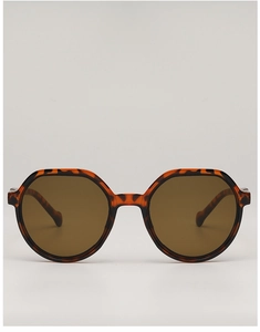 Macro detail of tortoiseshell acetate frame with dark brown lenses on retro sunglasses