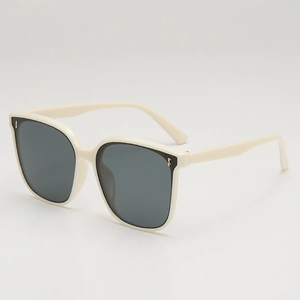 Creamy white oversized square sunglasses with dark grey lenses and metal stud accents