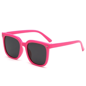 Fuchsia pink oversized kids sunglasses with silver star studs and dark UV lenses