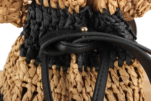 Close-up of dual-tone straw weave texture with black leather drawstring and gold metal bead