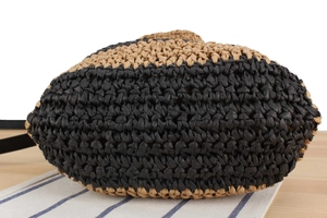 Detail of hand-woven striped tote bag base showing intricate texture and oval bottom structure