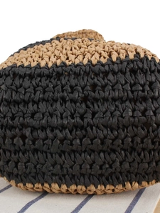 Two-tone woven straw shoulder bag with tan and black textures for summer beach holidays