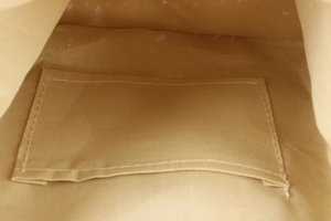 Detail of reinforced canvas bag interior with khaki lining and a flat inner pocket