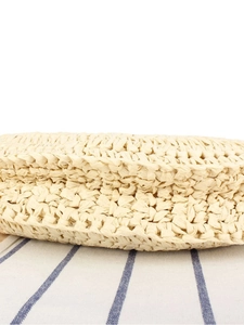 Handcrafted semicircular beige straw handbag with wooden handle for beach vacations