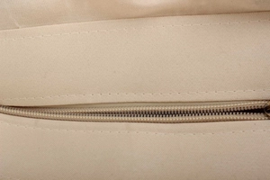 Macro view of smooth zipper closure and durable canvas texture on large tote bag