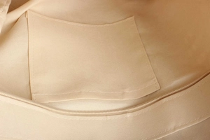 Detailed close-up of woven bag interior featuring a functional slip pocket and metal zipper