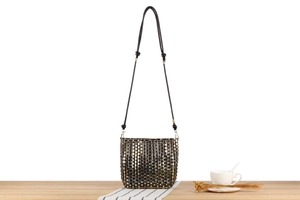 Detailed view of black and metallic woven crossbody bucket bag with adjustable strap