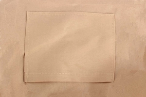 Detailed close-up of a sturdy woven pocket on a beige leisure woven bag with reinforced stitching