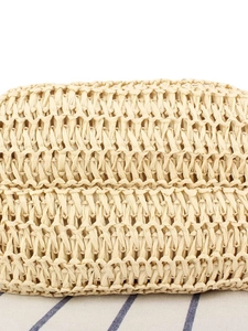 Handwoven straw tote bag for beach vacations with natural beige crossbody texture