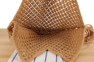 Top view of hollow mesh weave bag showing handmade texture and long fringe details
