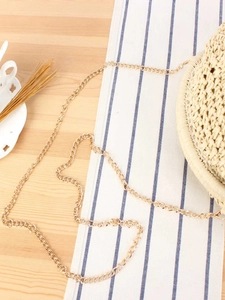 Minimalist beige woven straw crossbody bag with golden chain strap for summer vacations