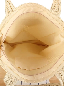 Woven straw tote bag interior featuring beige lining, zipper closure, and inner pocket