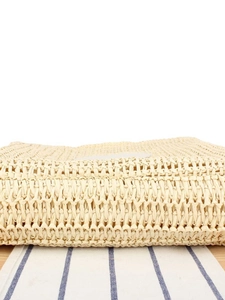 Handwoven straw shoulder bag with cross-weave texture for beach or casual use