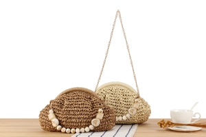 Detail of hand-woven cloud bags with marble bead handles and metal chain straps