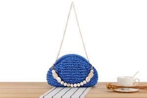 Detail of dark blue woven cloud bag with marble acrylic beads and gold chain strap