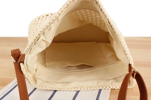 Detailed top view showing the spacious fabric interior and pocket of the woven bag