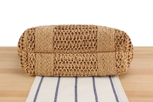 Detailed close-up of natural straw weave texture and reinforced pattern on woven tote bag