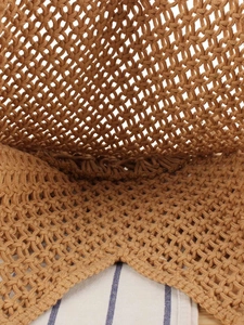 Detailed top view of handmade hollow mesh woven bag with natural fringe texture and lining