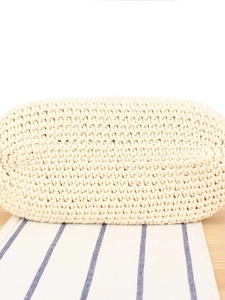 Bottom view of minimalist off-white woven shoulder bag with detailed texture