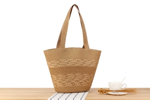 Close-up of wave weave pattern on beige woven tote bag with Nordic style props