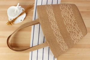 Macro shot of textured woven straw pattern on a beige summer tote bag for women
