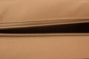 Detailed macro view of high-quality brown woven fabric and durable matching zipper