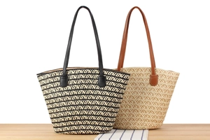 Detail of two woven tote bags in monochrome pattern and natural straw with leather handles