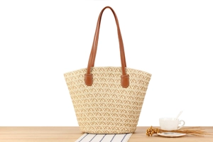 Close-up of handwoven tote bag featuring geometric texture and brown leather straps